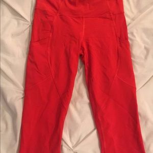 Red Lululemon crop leggings with pocket detailing